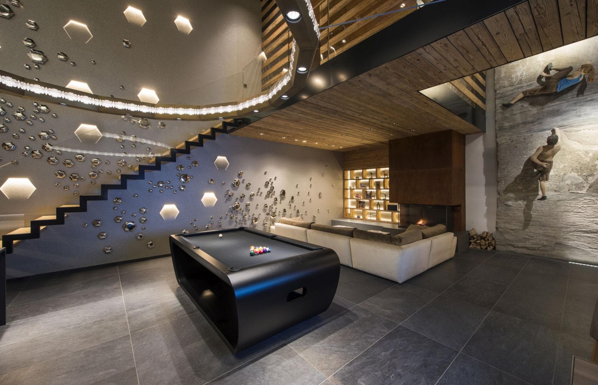 Game room with pool table, sectional seating, and indoor climbing wall