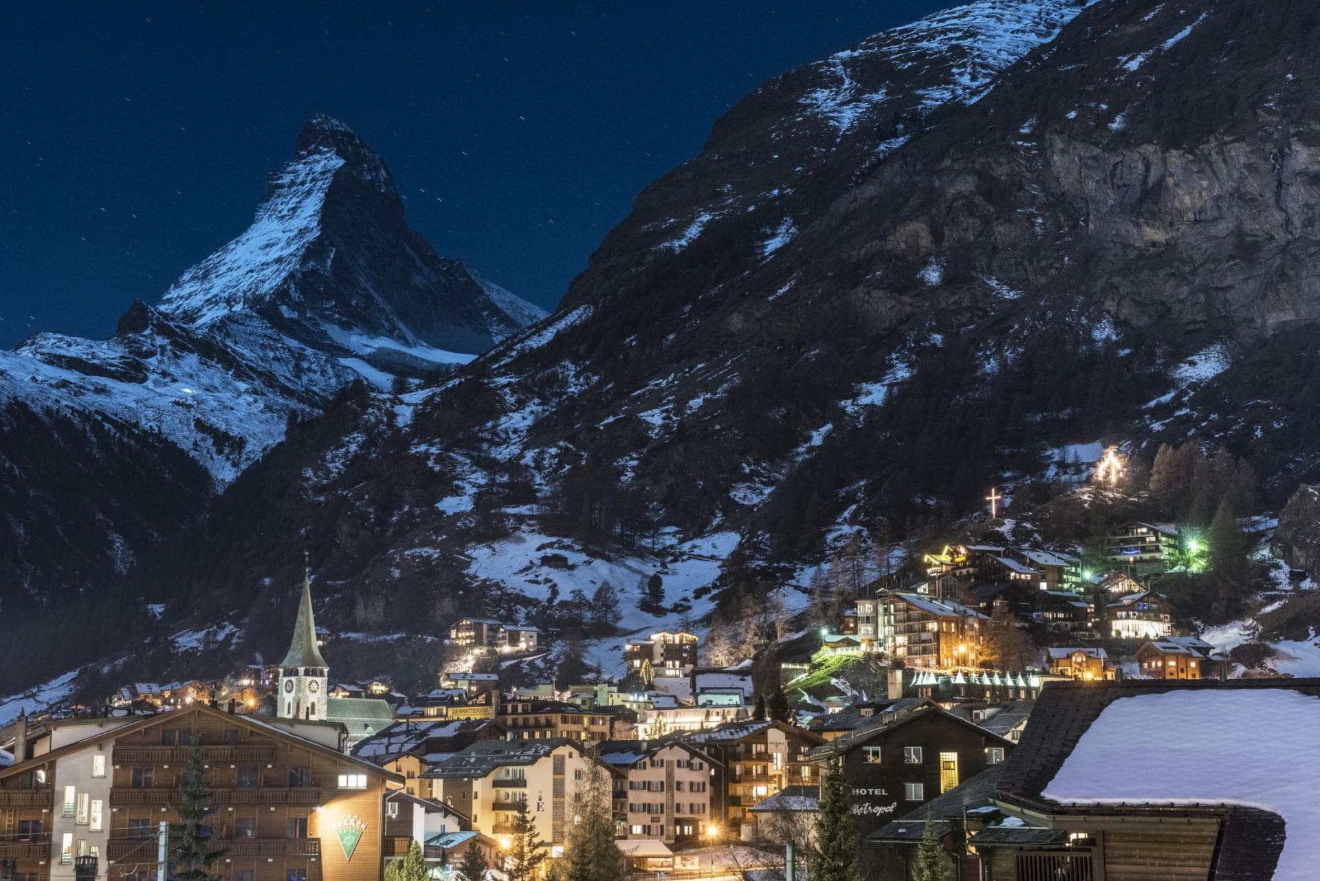 Zermatt village at night with Matterhorn peak and historic church tower