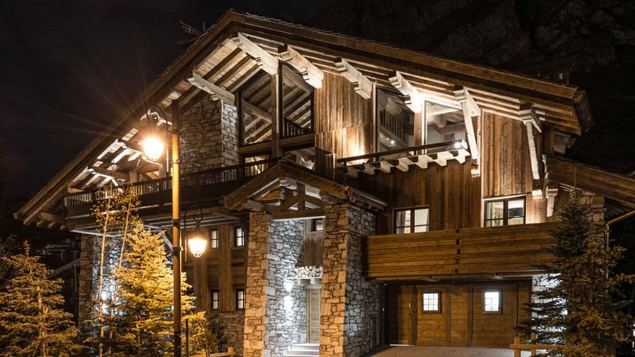 Chalet exterior with stone masonry and private garage access