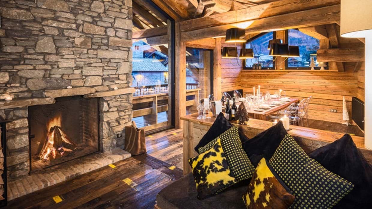 Open living area with wood-burning fireplace and dining seating for 8