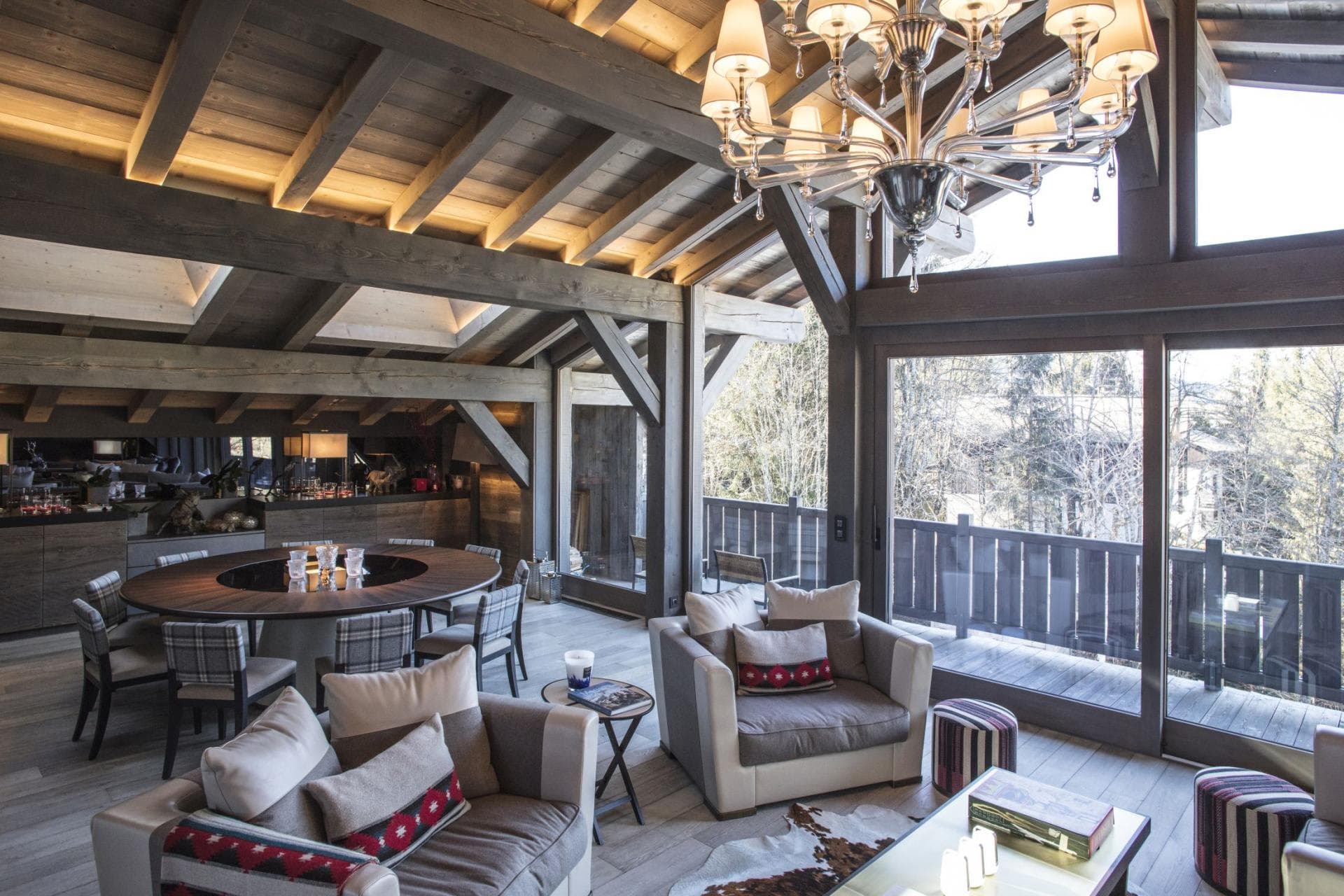 Open living area with vaulted timber ceilings and deck access