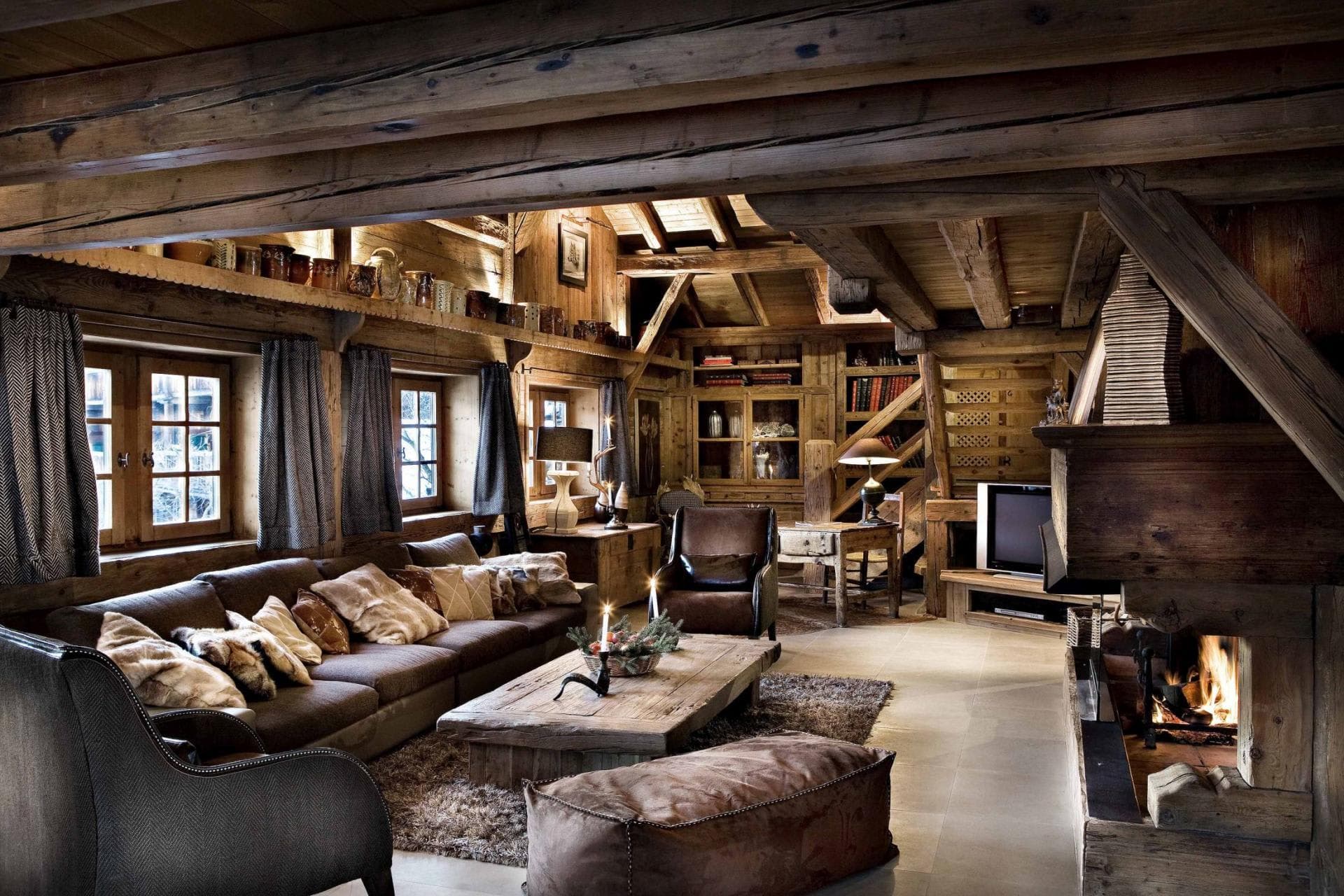 Living area with wood-burning fireplace and exposed timber beams