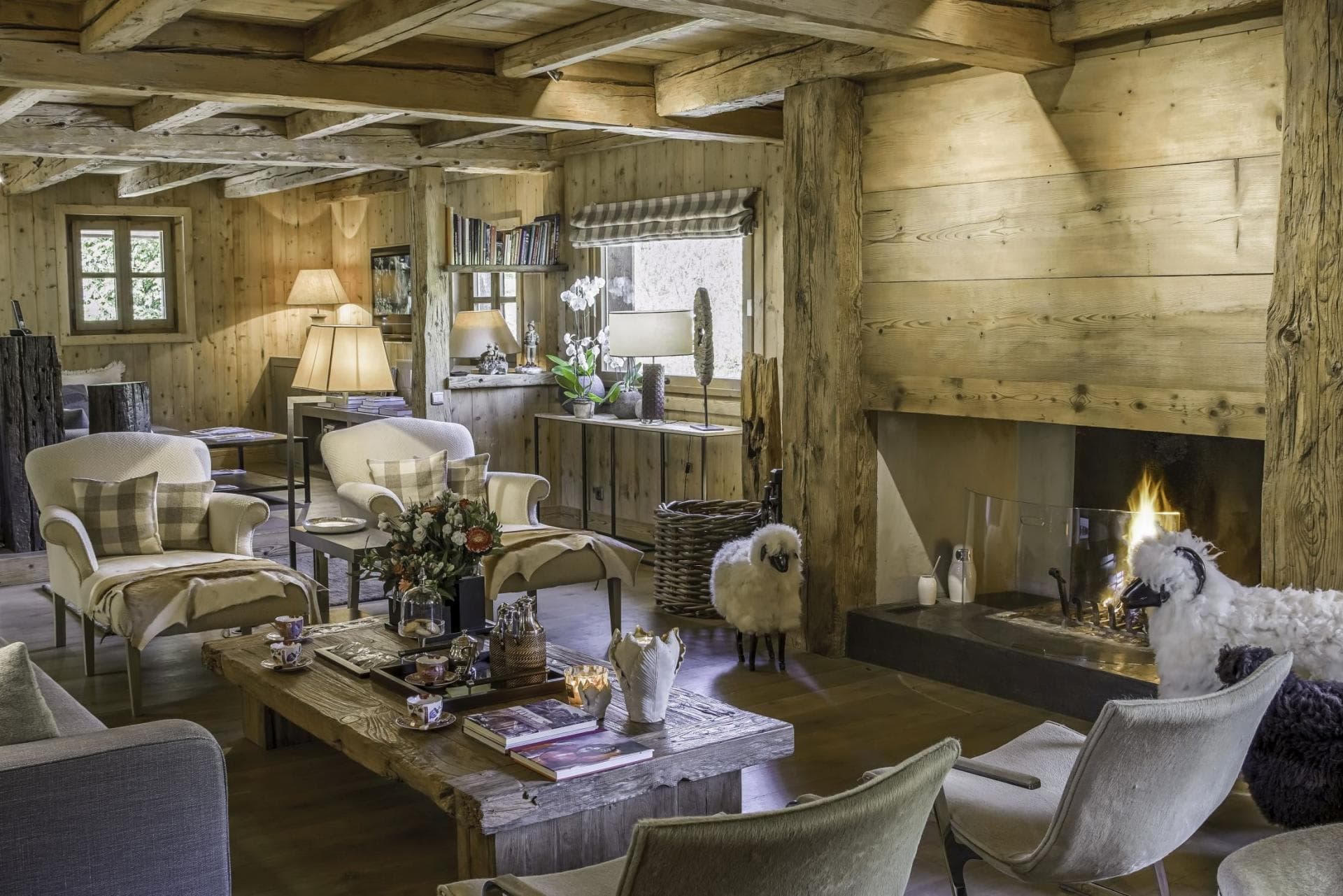 Living area with wood-burning fireplace and original timber beams