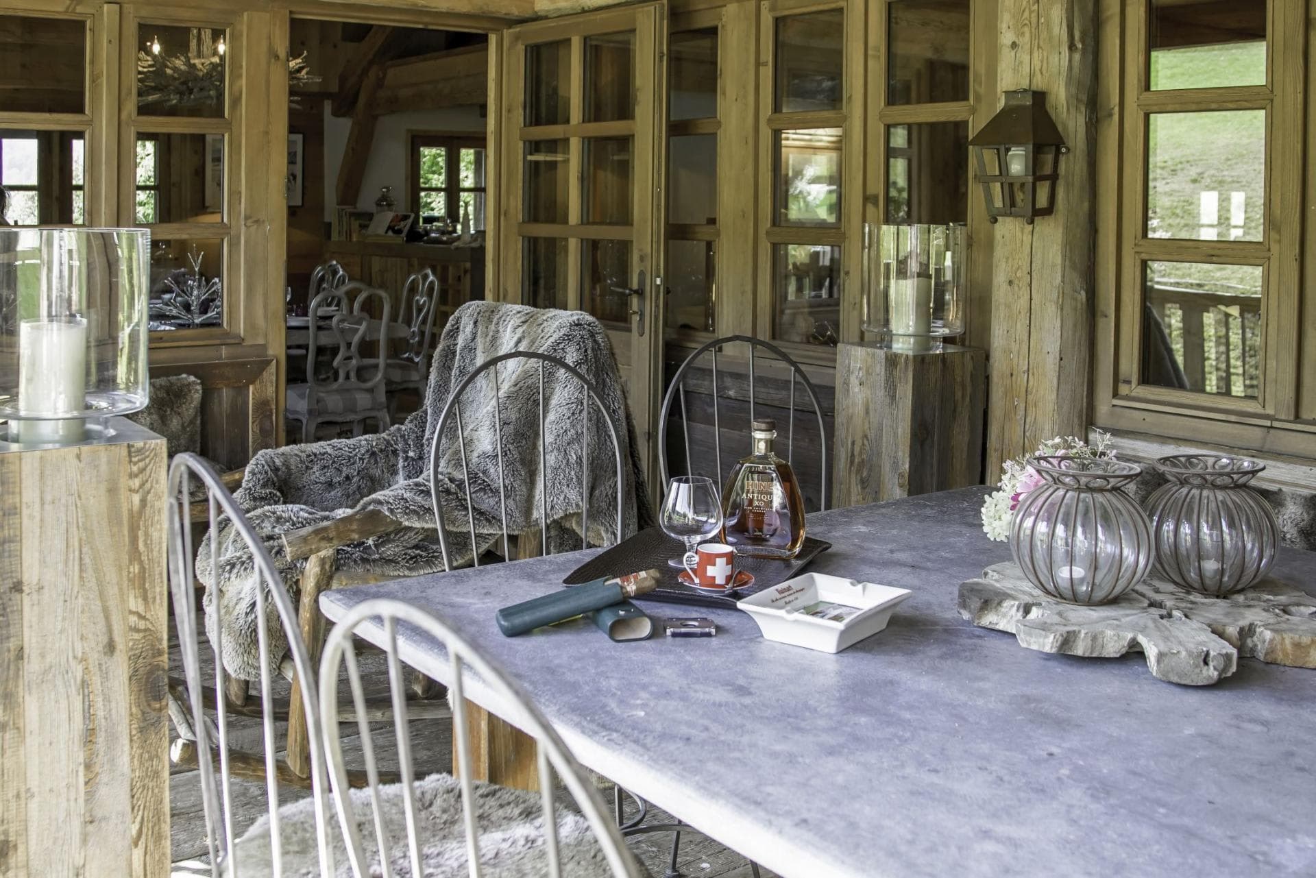 Covered terrace with stone dining table and direct indoor access