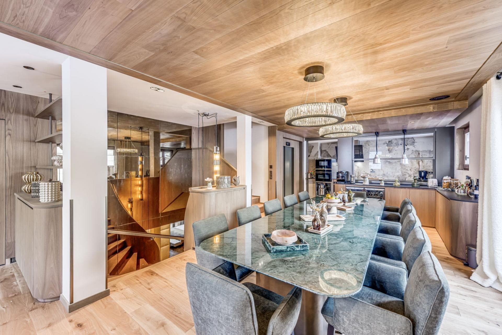 Dining area seats 12; stone table adjacent to kitchen and stairs