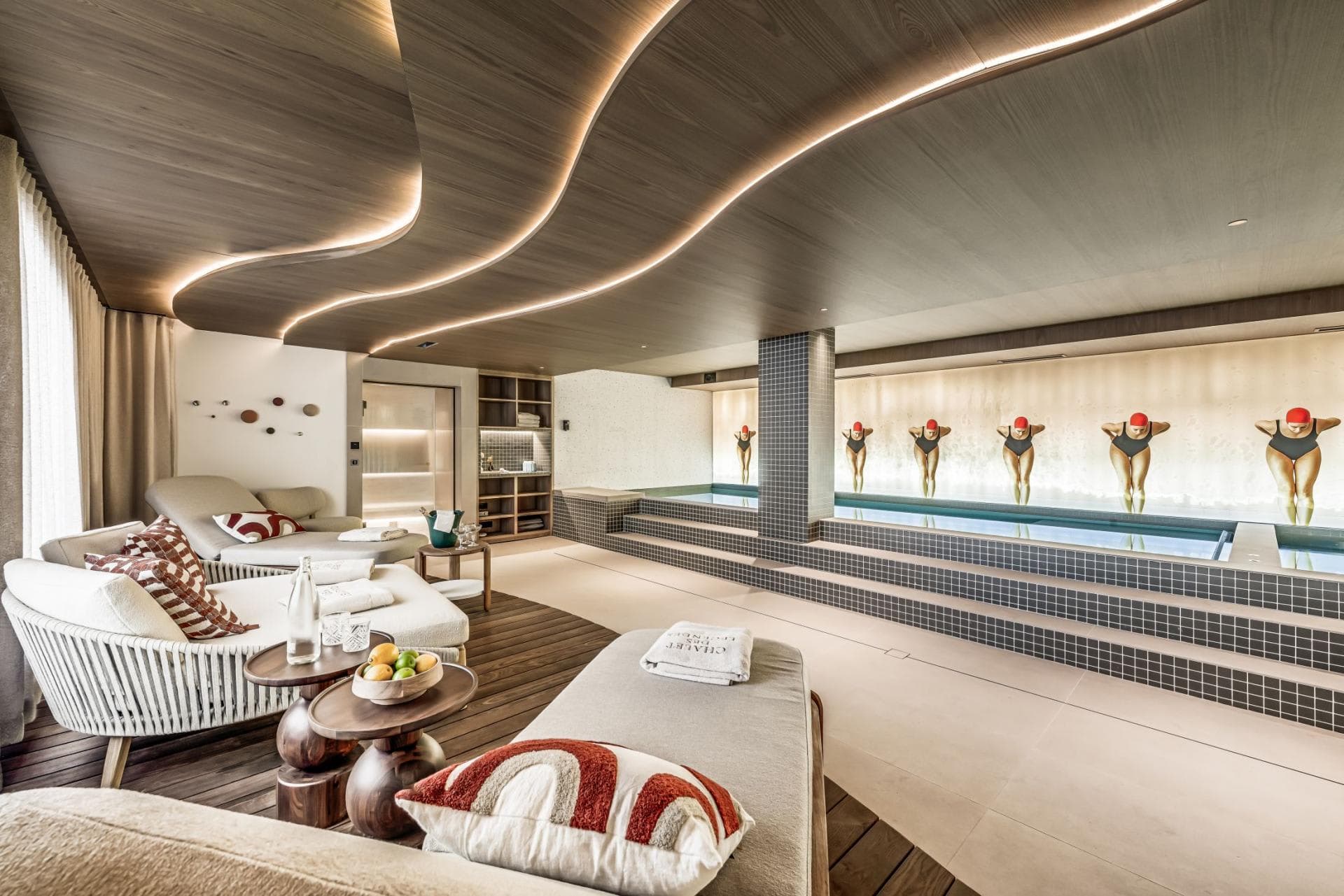 Indoor pool and spa area with daybeds and sauna access