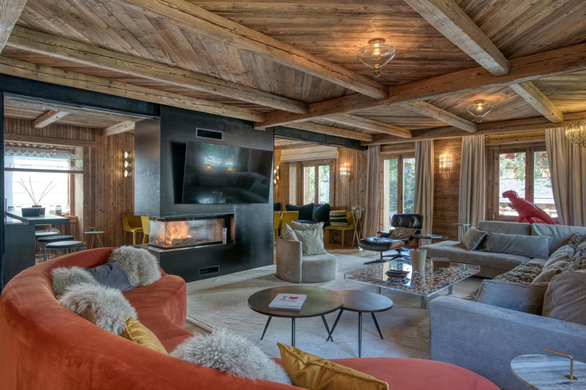 Living area with wood-burning fireplace, Smart TV, and curved sectional seating