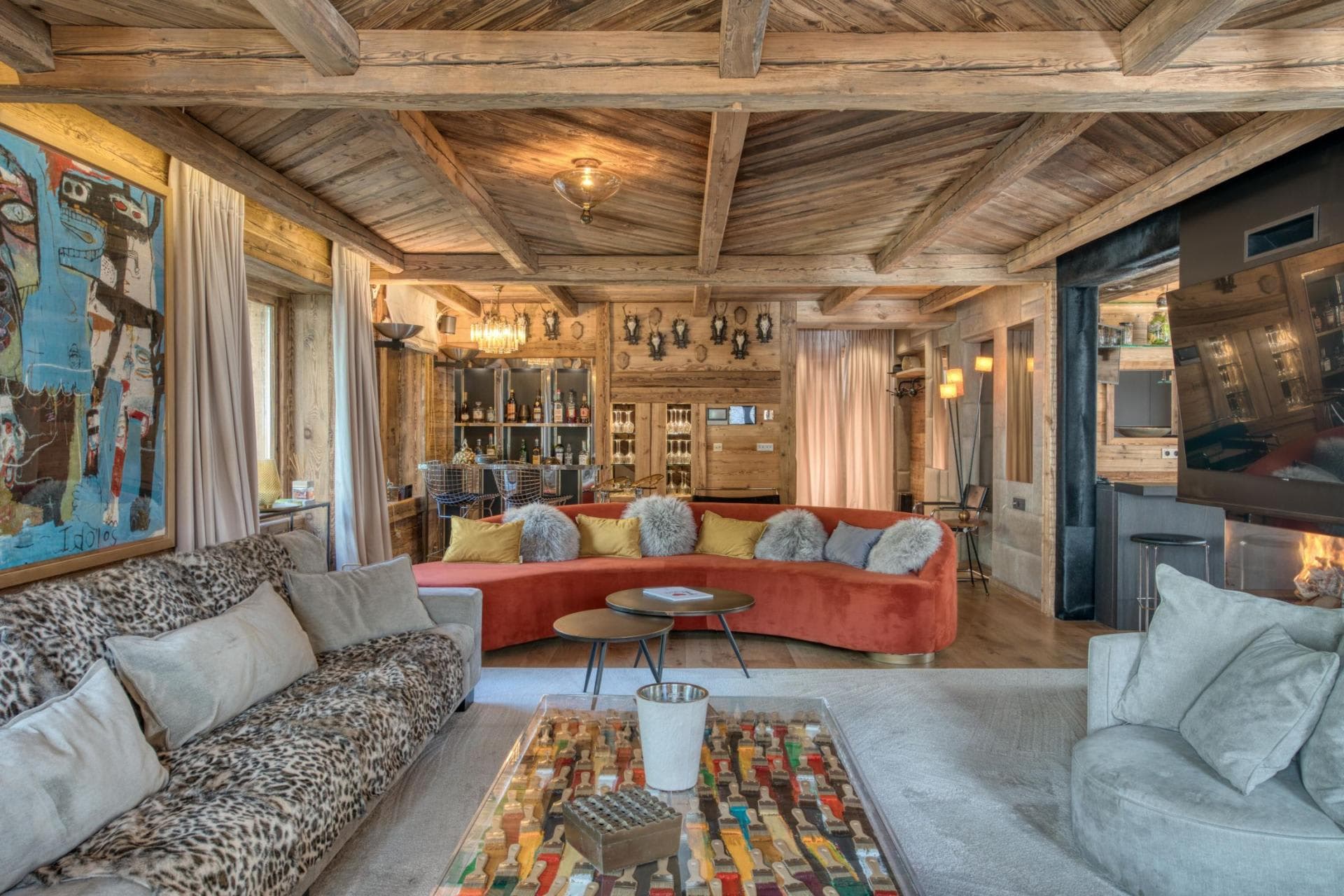 Living area with wood-beamed ceiling, bar, and fireplace