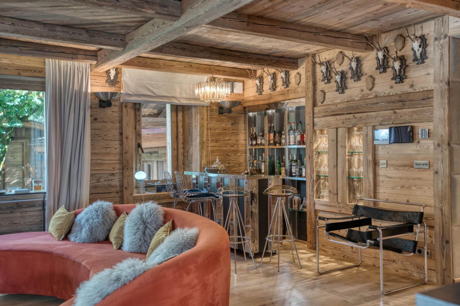 Lounge area with mirror-finish wet bar and barstool seating