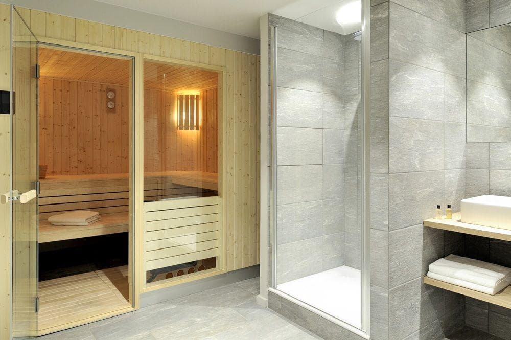 Private sauna and walk-in shower with stone tile