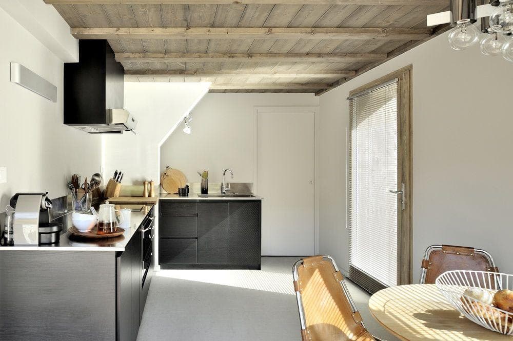 Kitchen with Nespresso machine, induction cooktop, and reclaimed wood ceiling