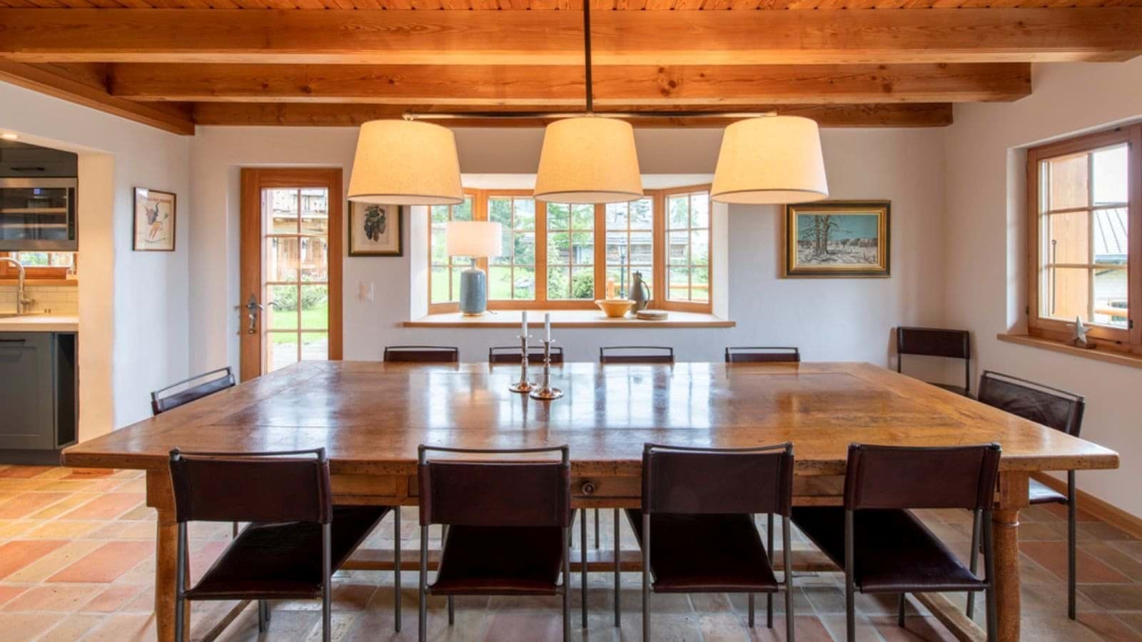 Dining table seats 12; terracotta flooring and exposed wood beams
