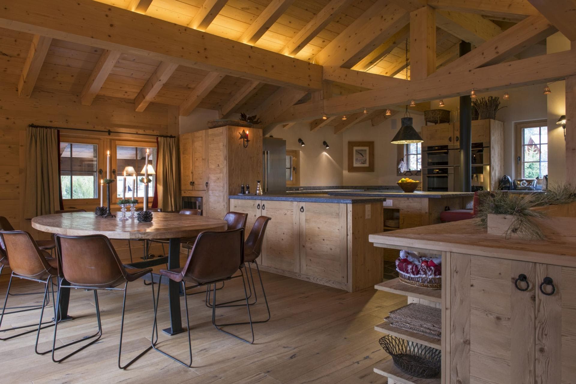 Open dining area and kitchen with vaulted timber ceilings and seating for 6