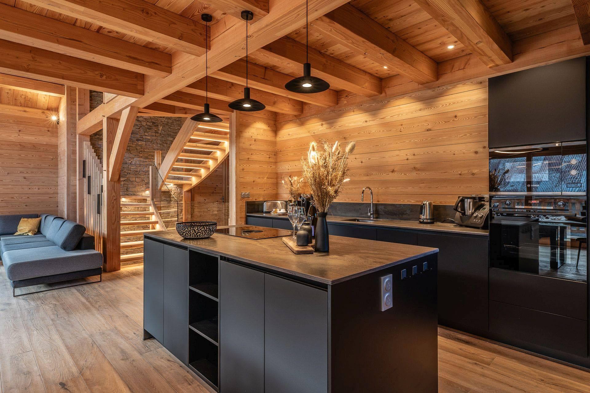 Open-plan kitchen with induction cooktop and stone-top island