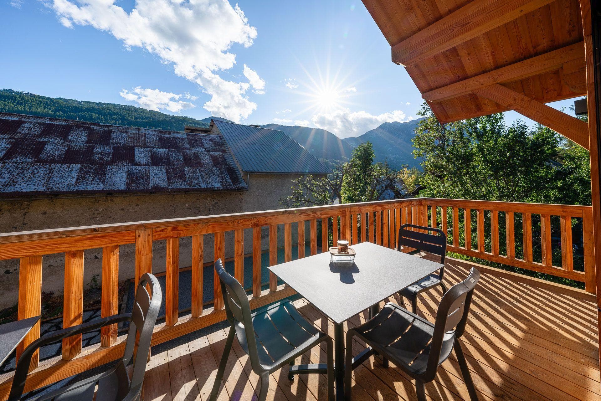 Covered balcony with dining table for 4 and mountain views