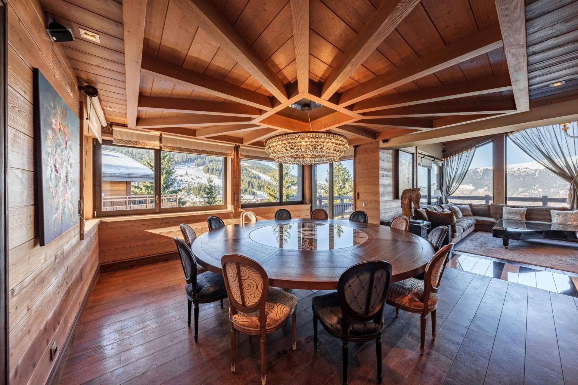 Round dining table seats 10; wrap-around windows with mountain views
