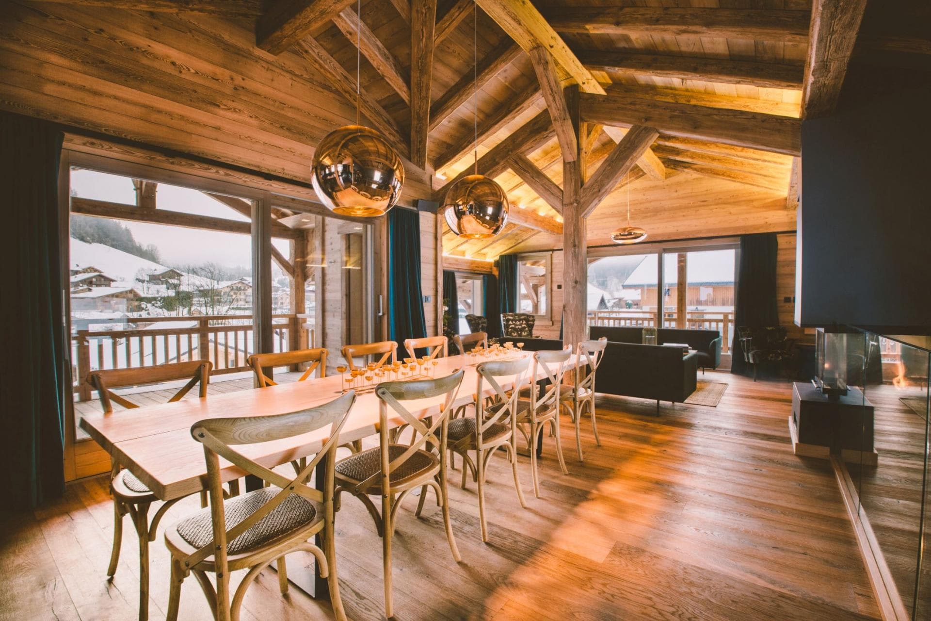 Open-plan dining area seats 10; adjacent living room with glass-enclosed fireplace