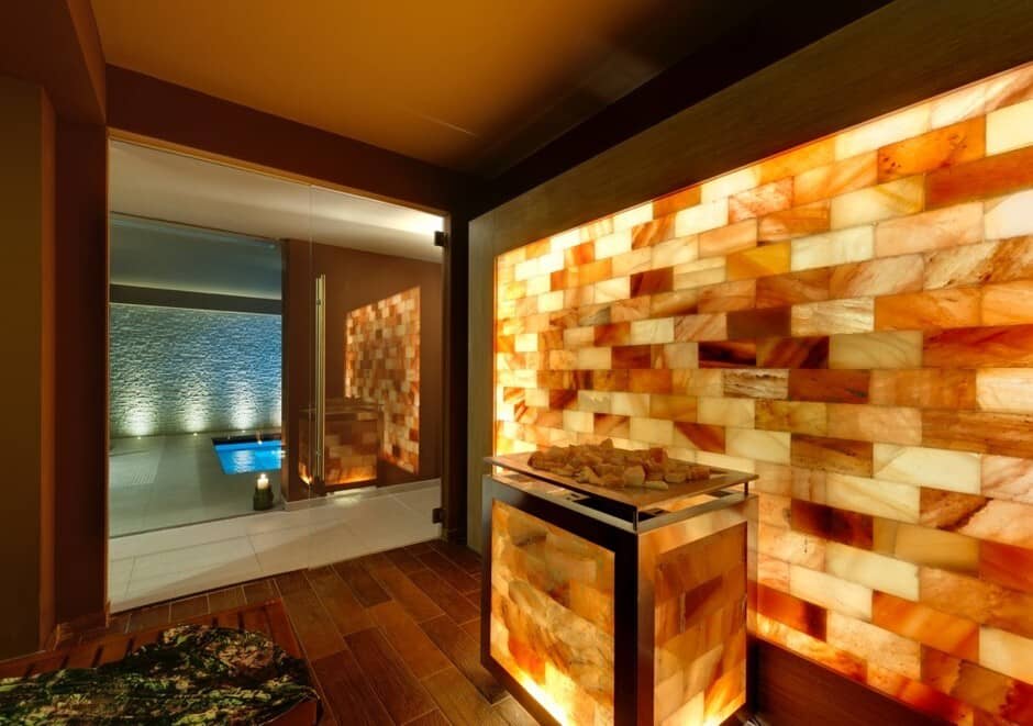 Himalayan salt sauna with glass door view of indoor pool