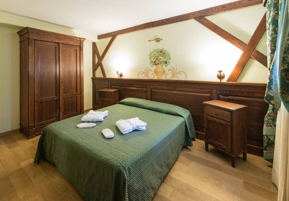 Guest bedroom with queen bed and hand-painted mural detail
