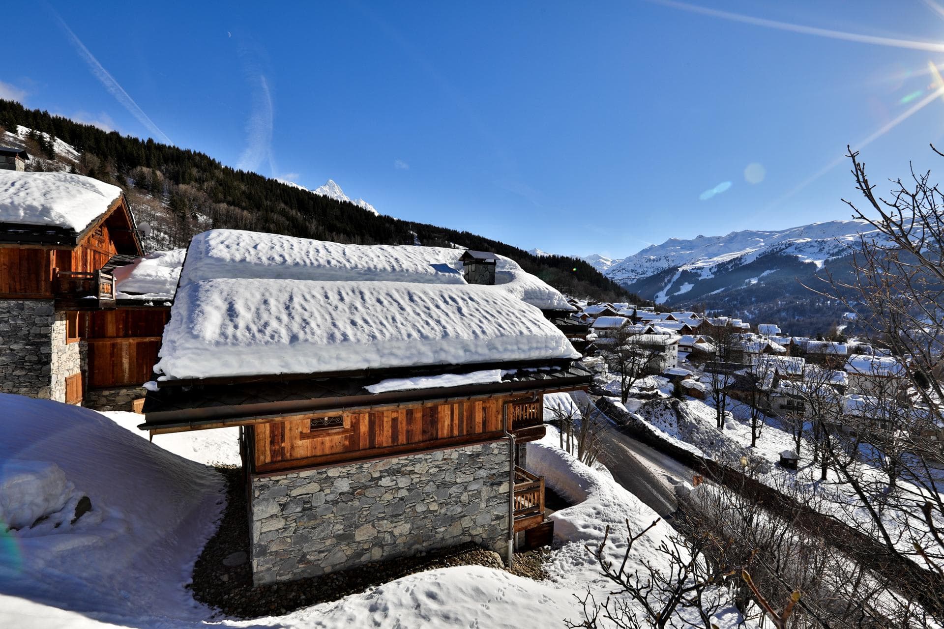 Stone and timber chalet exterior with mountain valley views