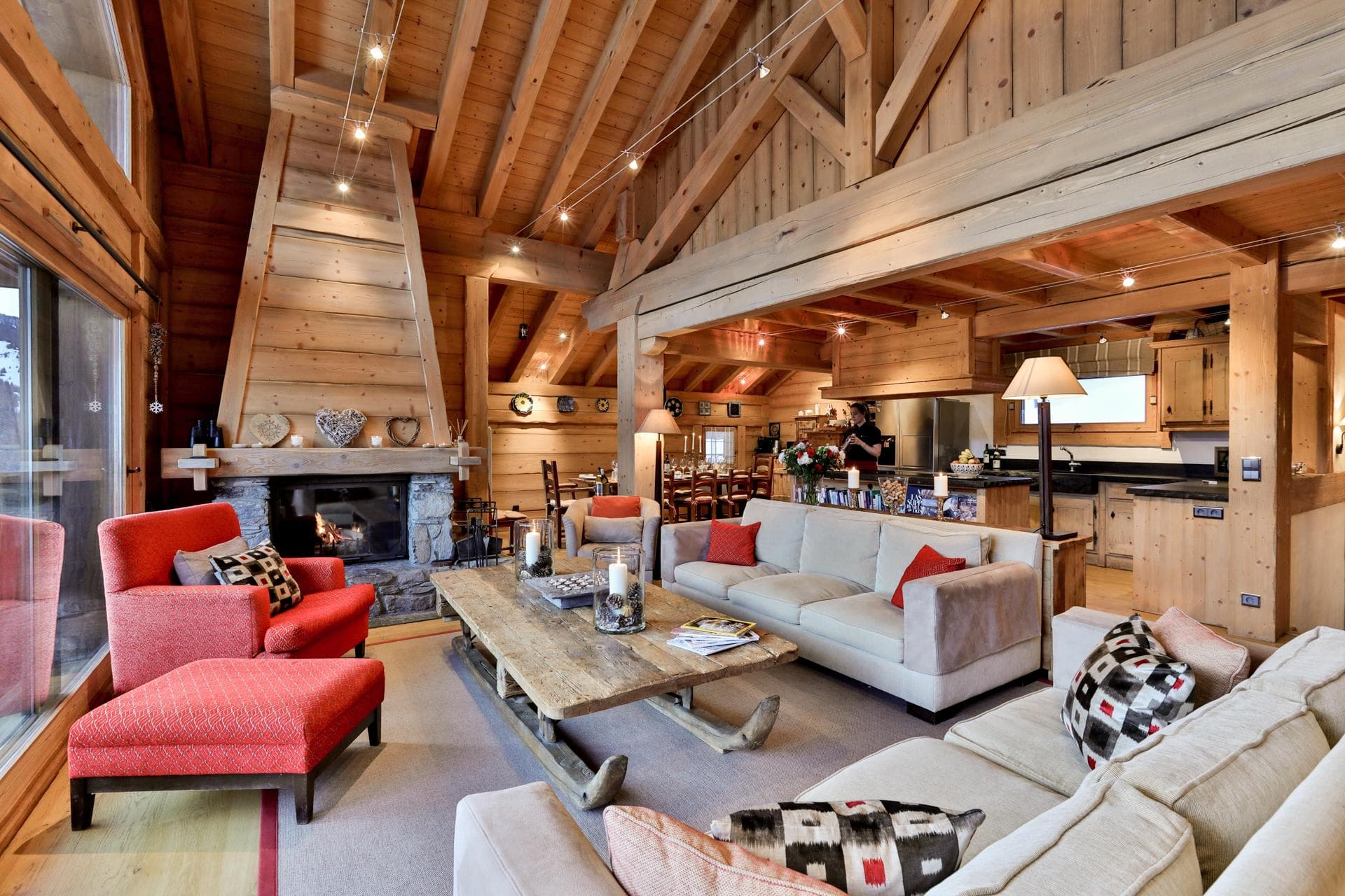 Open-plan living area with wood-burning fireplace and sled-style coffee table