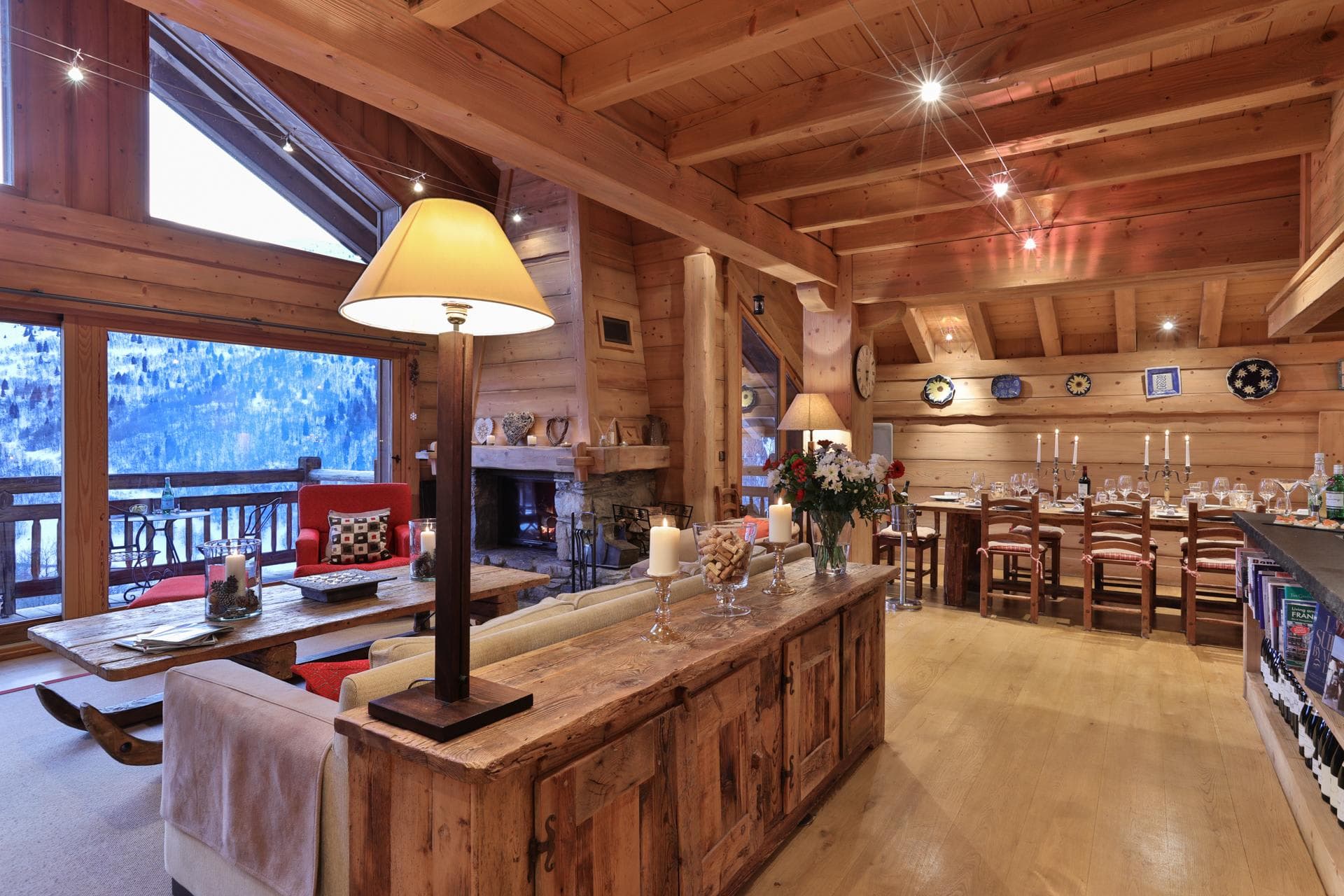 Open-plan living area with wood-burning fireplace and dining seating for 8