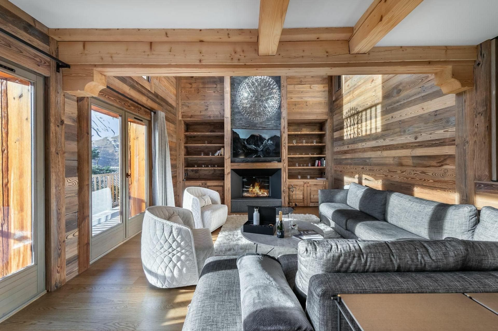 Living area with wood-burning fireplace and balcony access to mountain views