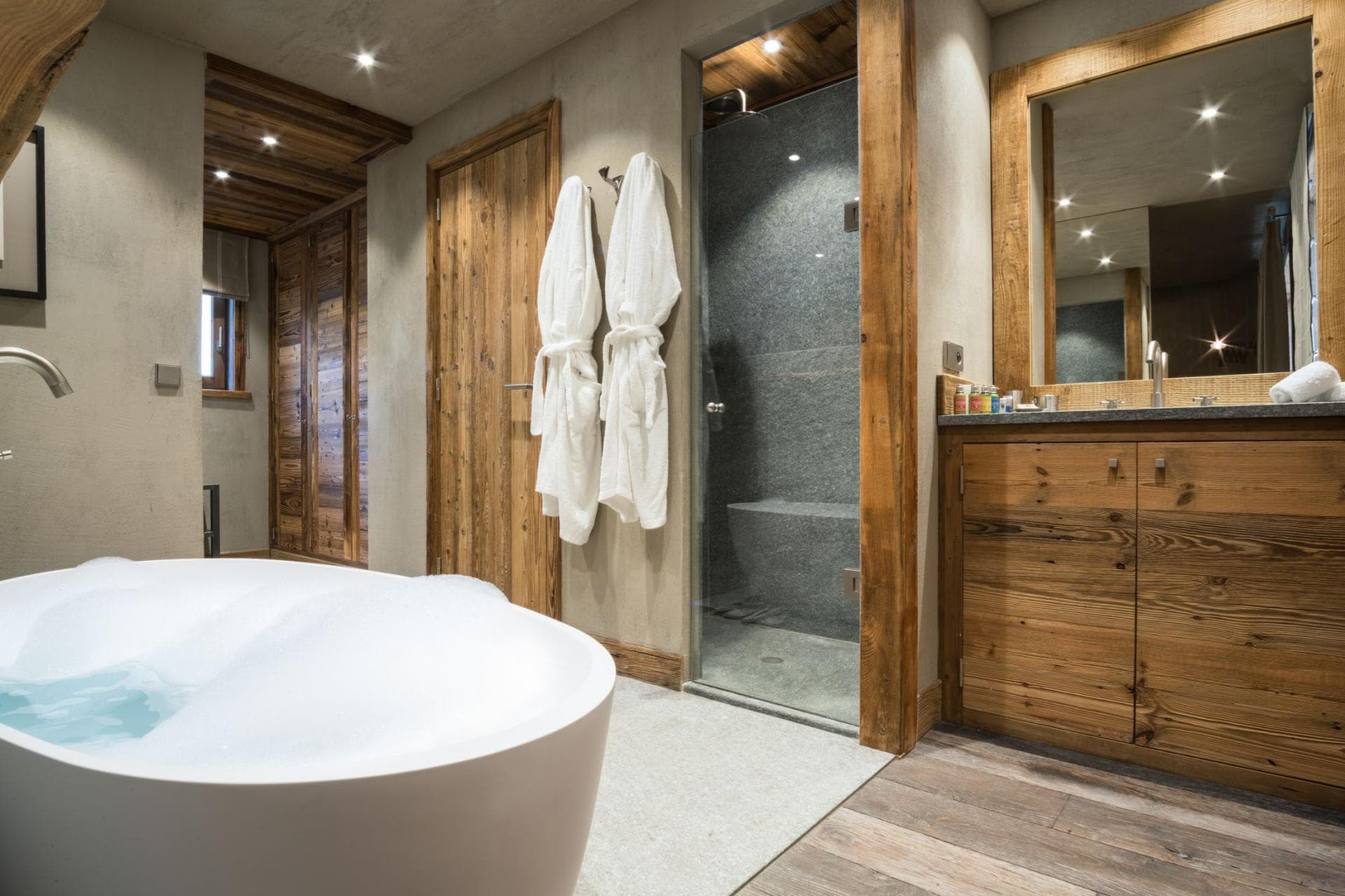Bathroom with soaking tub and walk-in steam shower with bench
