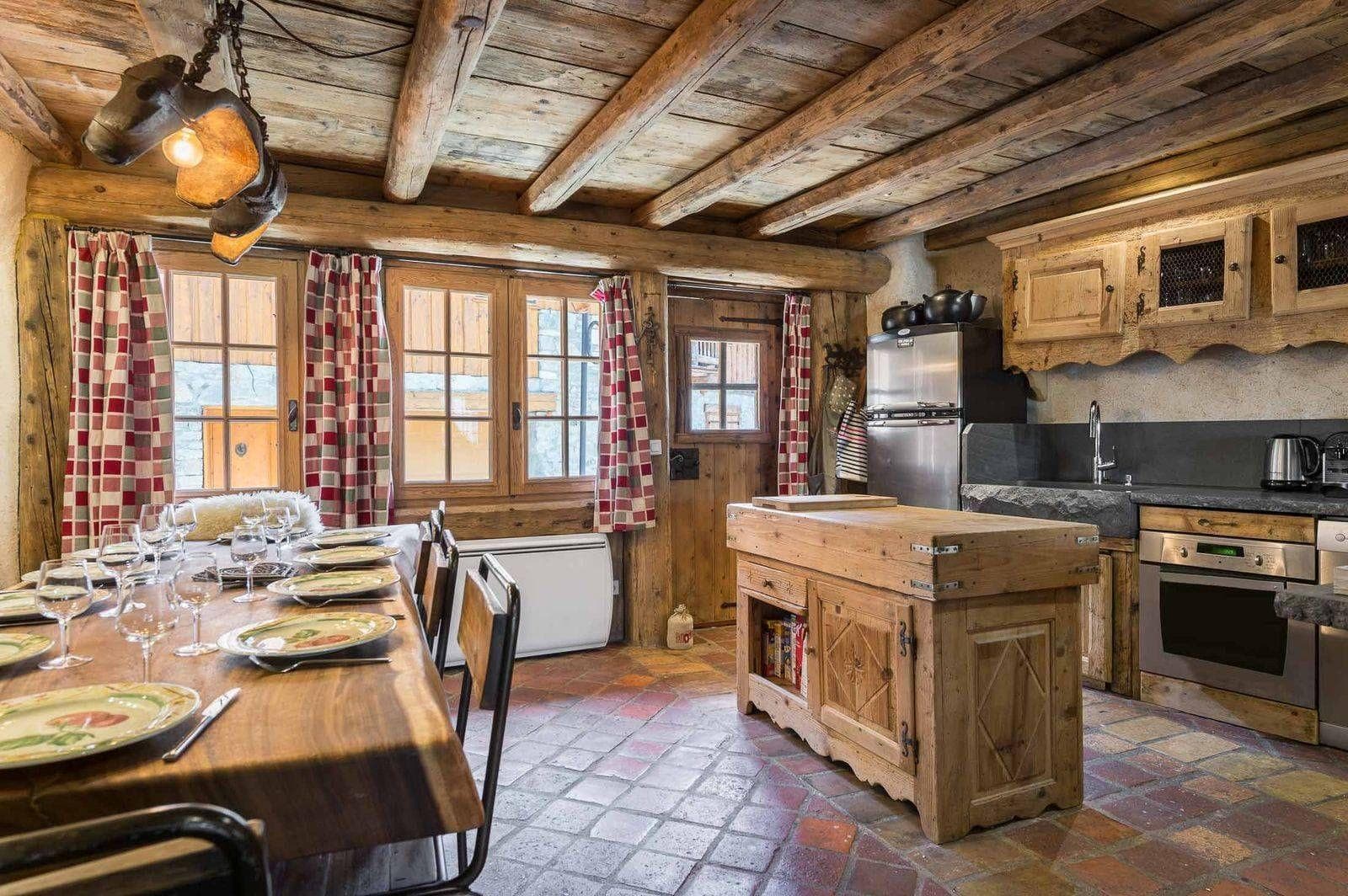 Kitchen and dining area with butcher block island and stone basin sink