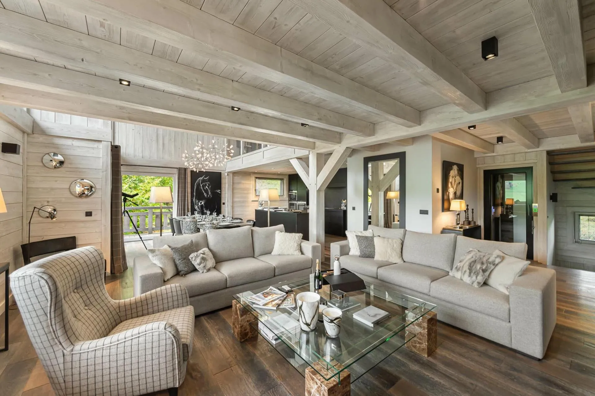 Sofas around a low table beneath timber beams