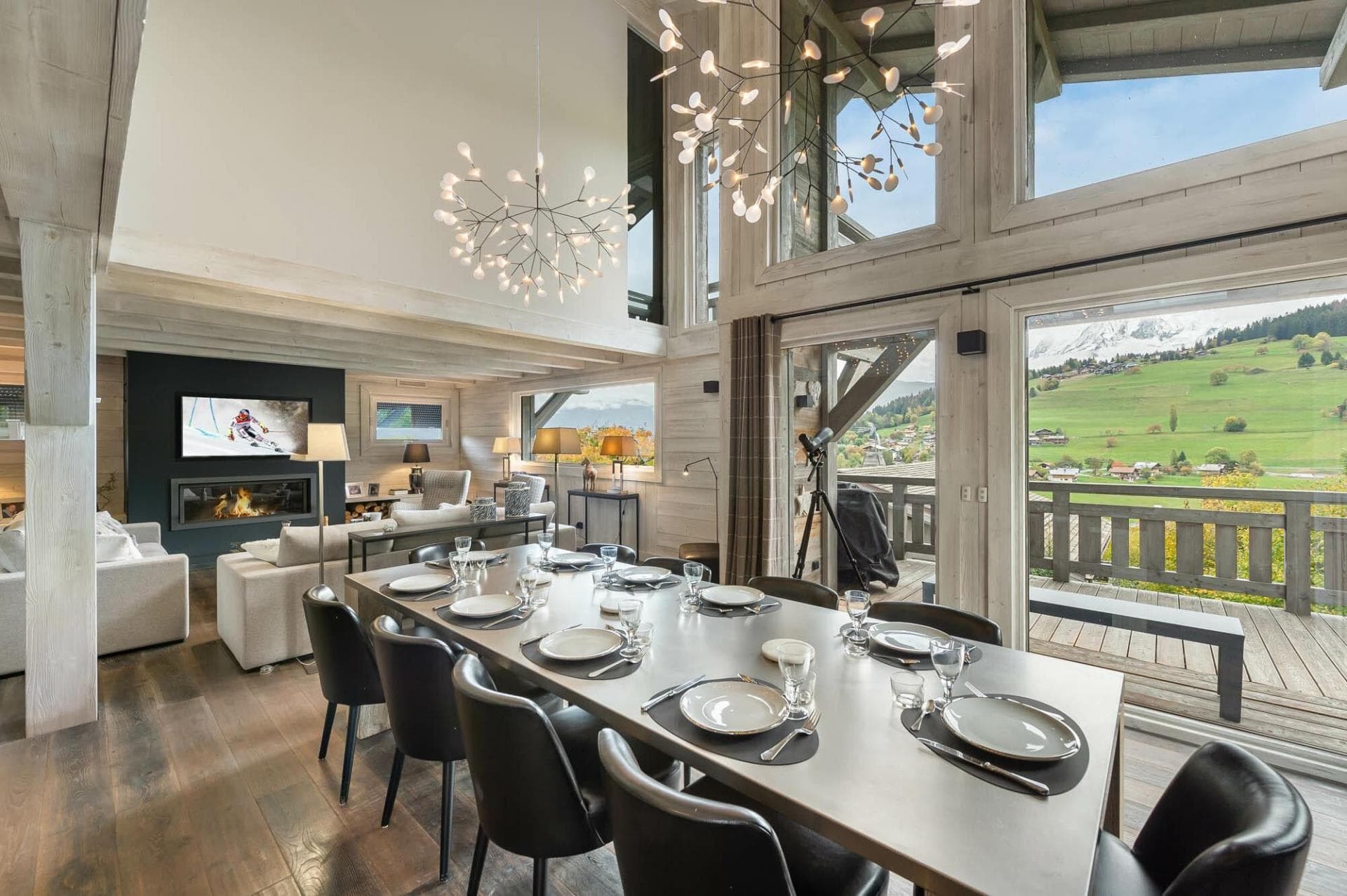 Open-plan dining area seats 10 with mountain views and adjacent fireplace