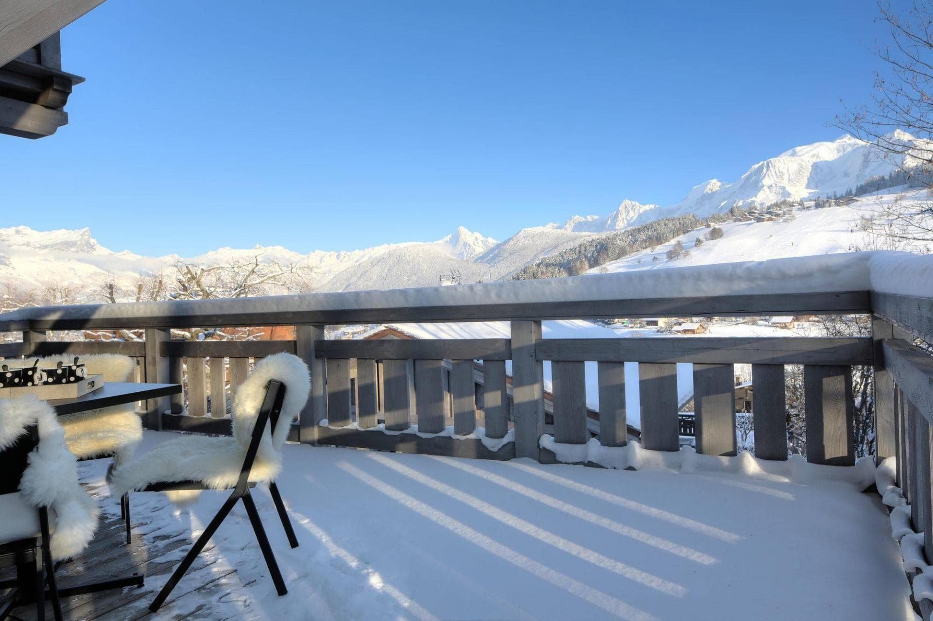 Private terrace with fur-lined seating and panoramic Mont Blanc views
