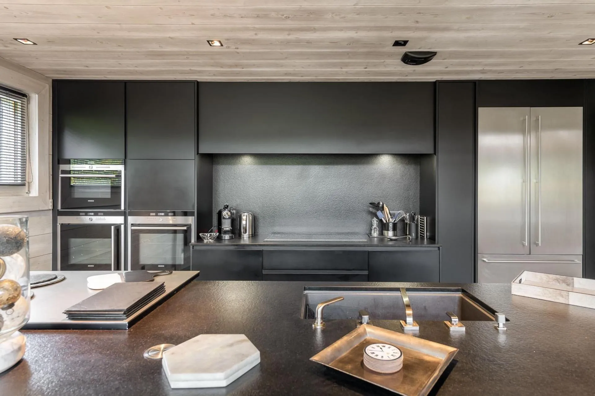Dark fitted kitchen with integrated appliances