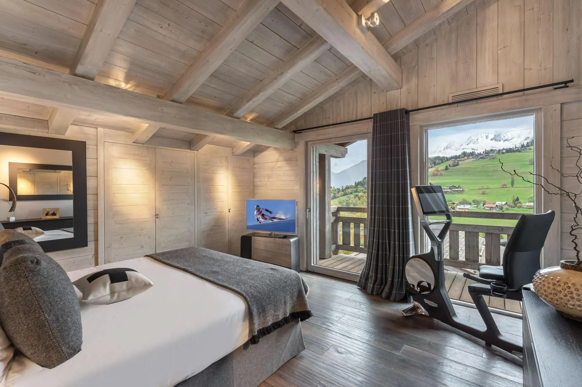 Double bedroom with balcony doors and exercise bike