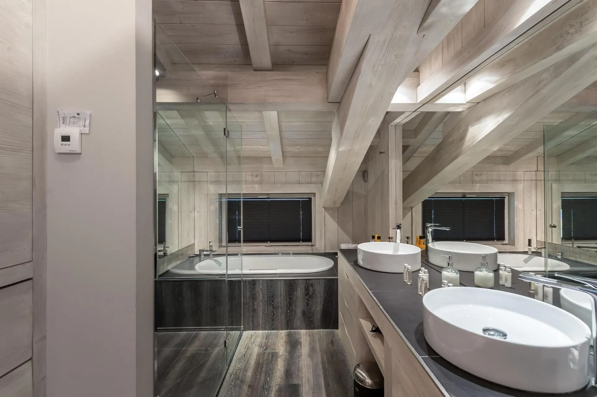 Bathroom with bathtub and twin basins