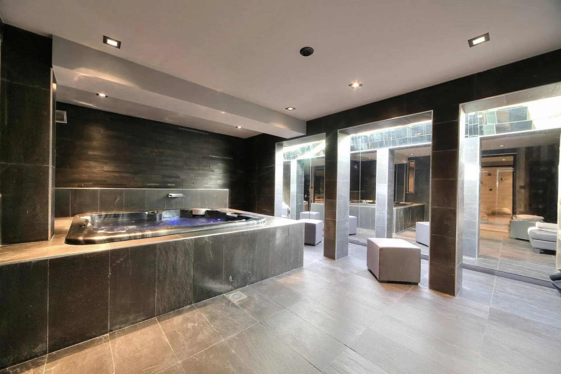 Indoor hot tub beside large windows