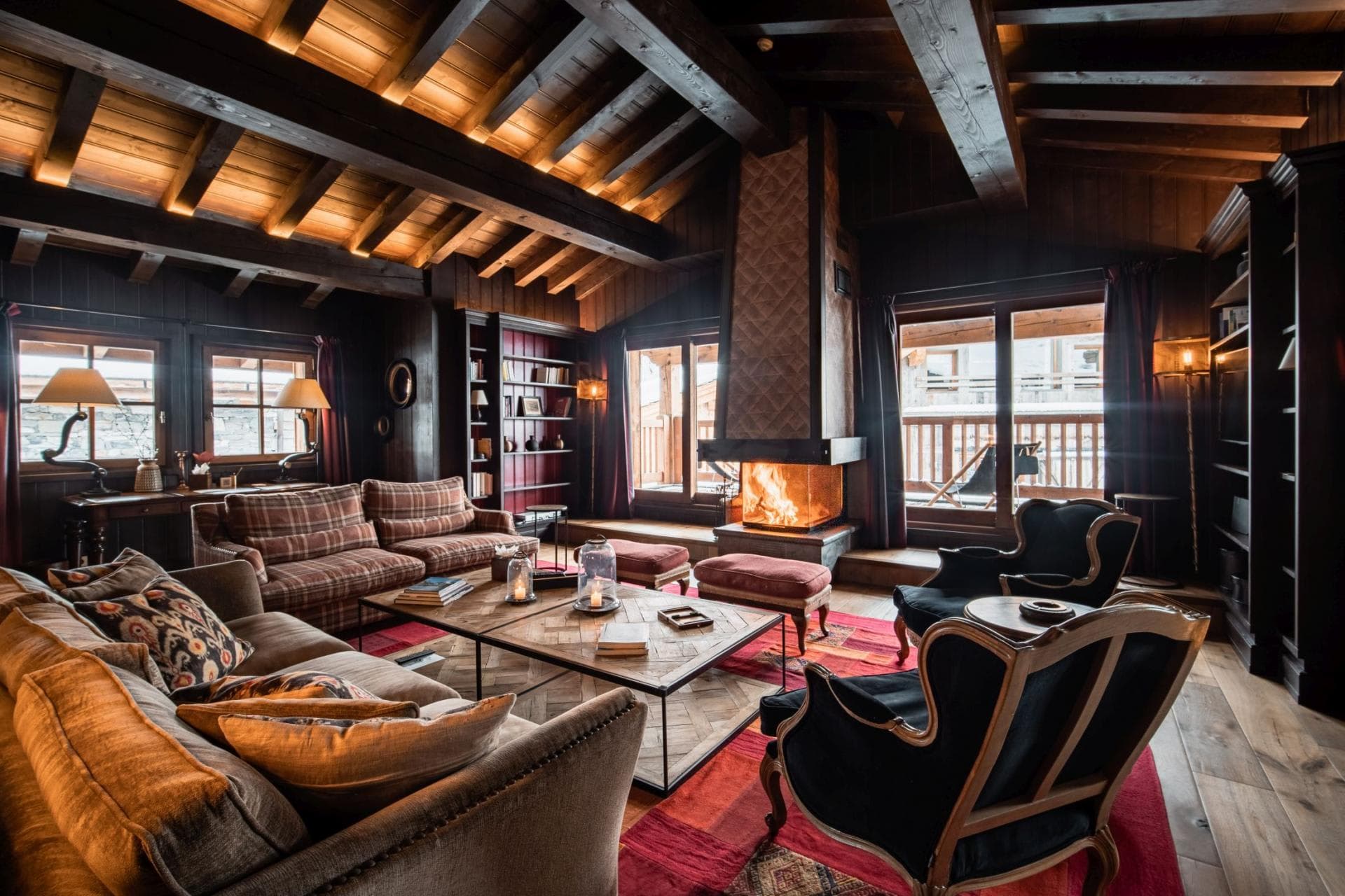 Living area with wood-burning fireplace and exposed timber beams