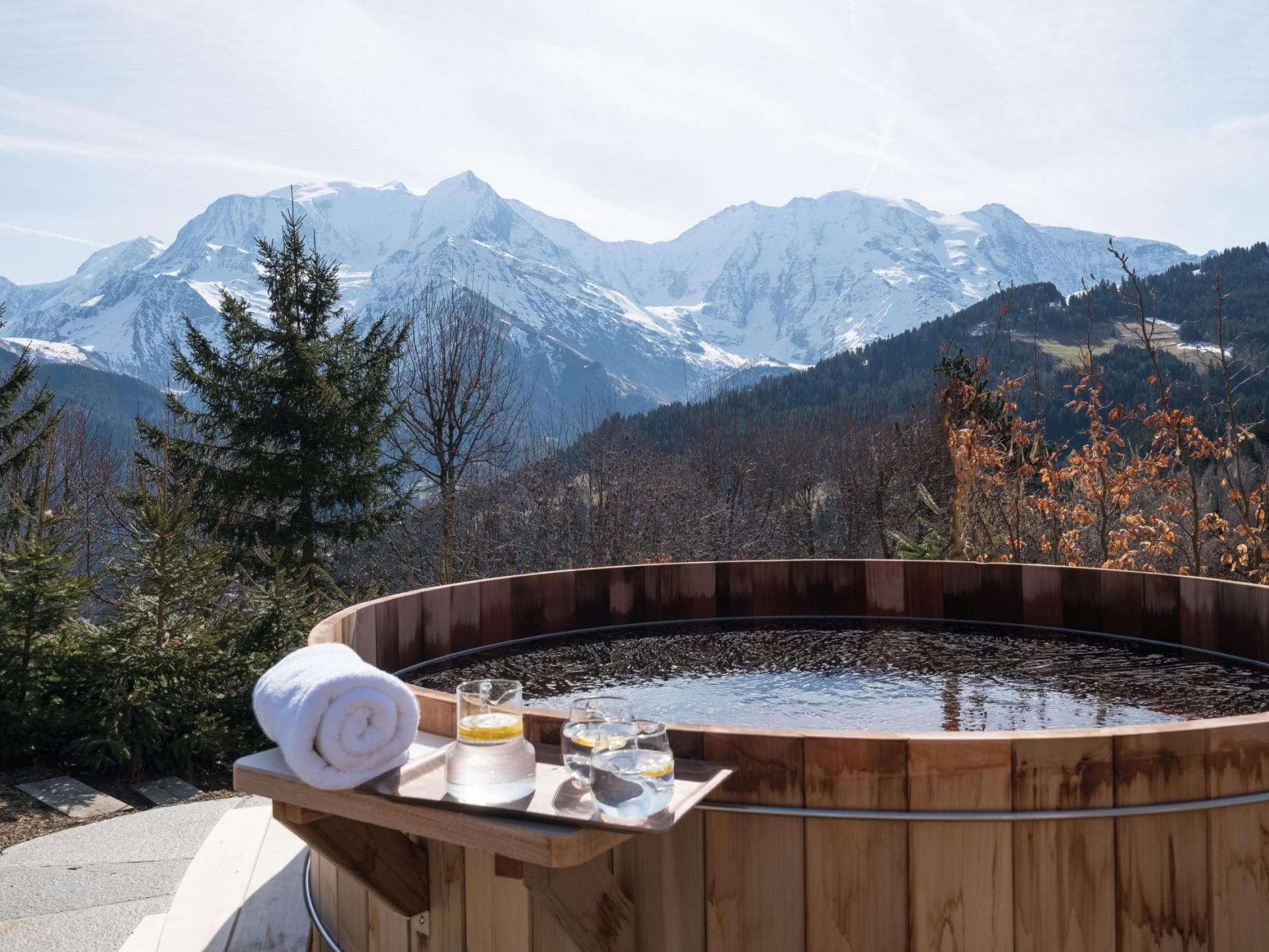 Outdoor cedar hot tub with panoramic mountain views