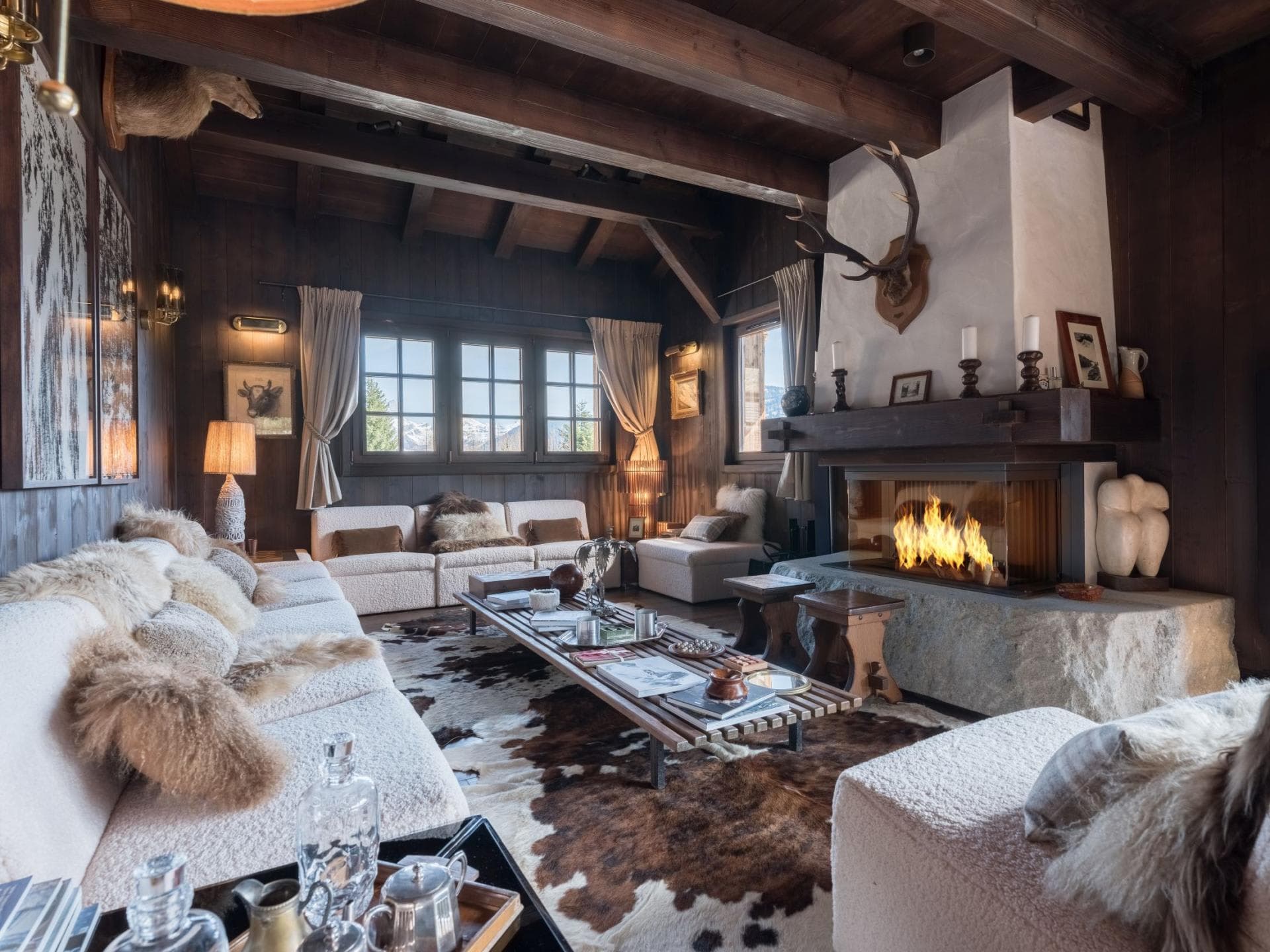 Living room with wood-burning stone fireplace and seating for 10