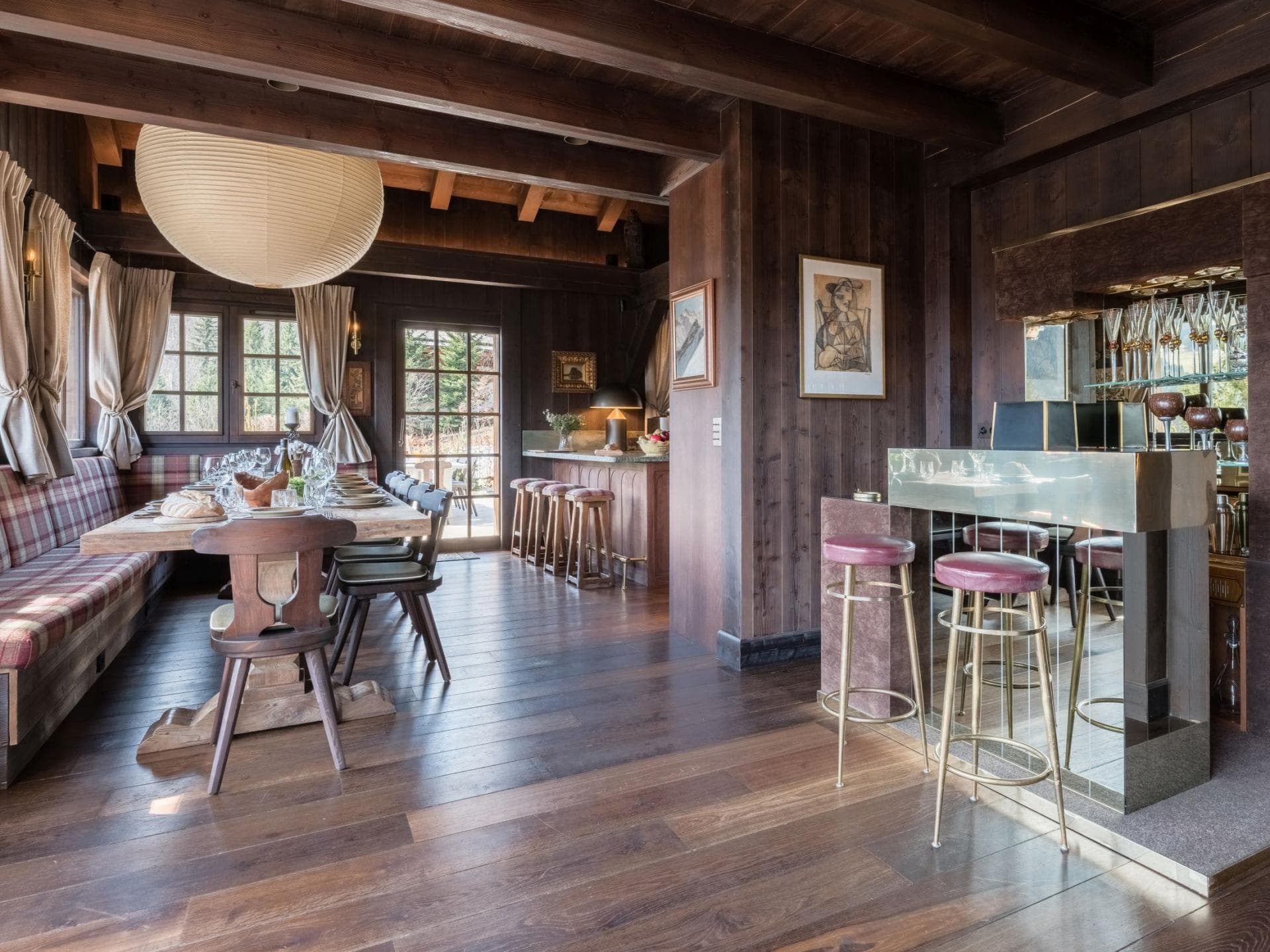 Dining area with banquet seating for 8 and adjacent brass wet bar