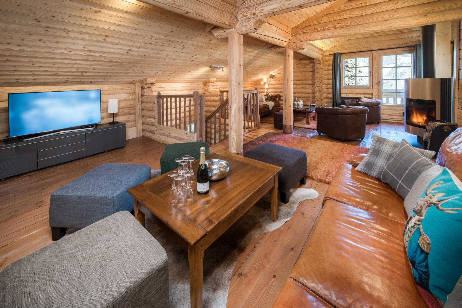 Lofted living area with wood stove and large screen TV