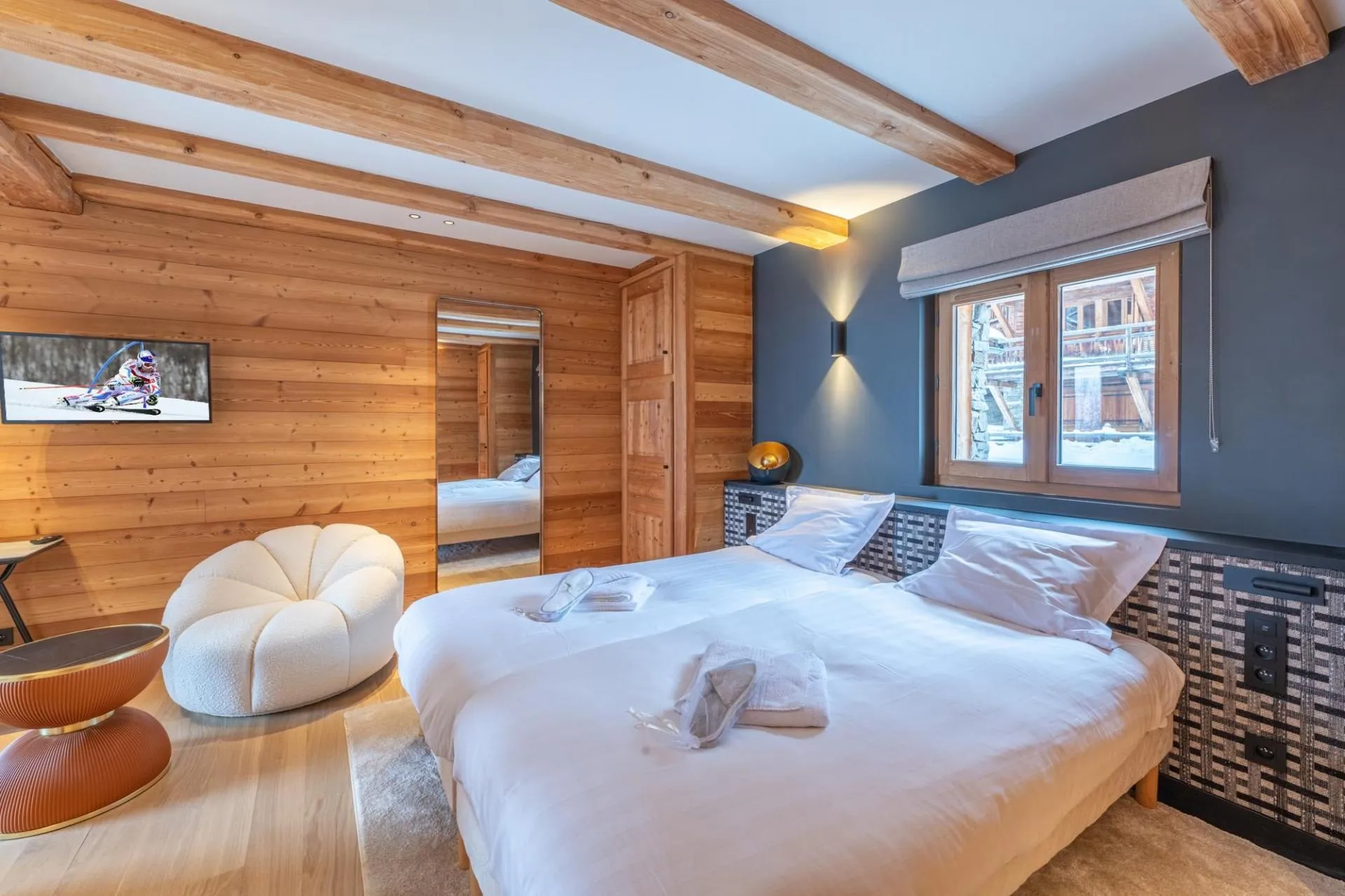 Twin bedroom with timber beams and two single beds