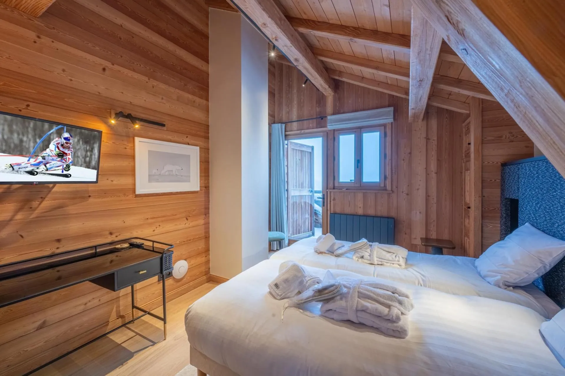 Twin bedroom with television and two single beds