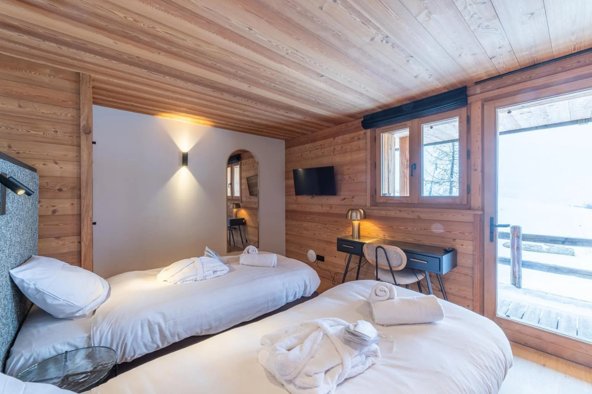 Twin bedroom with two single beds, desk and timber finishes