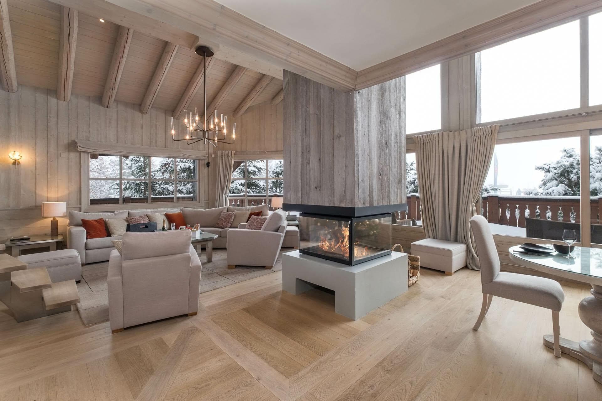 Open living area with three-sided glass fireplace and vaulted wood ceilings