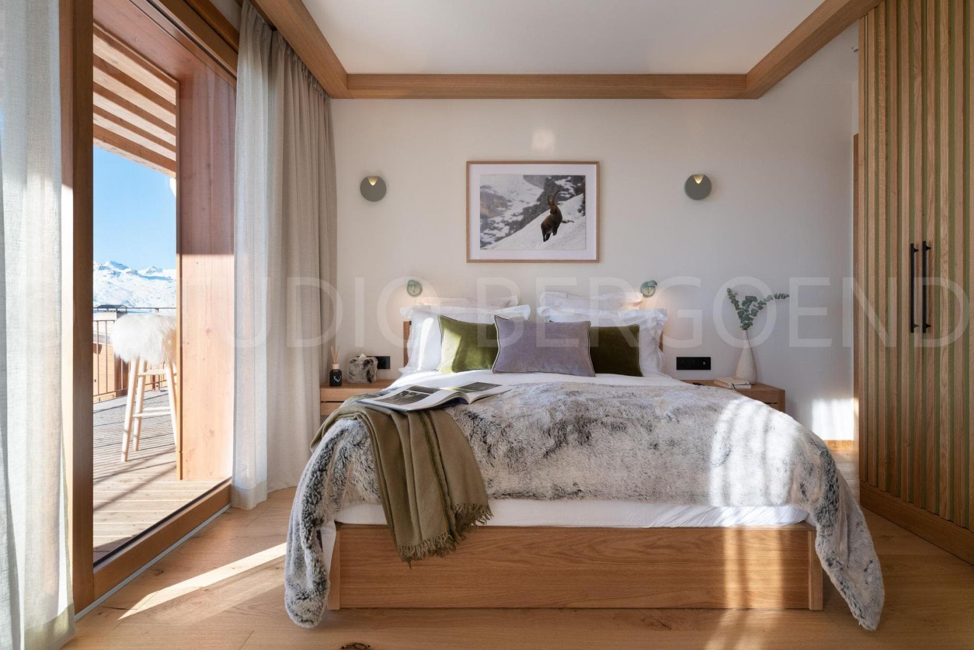 Primary bedroom with king bed and private balcony mountain views