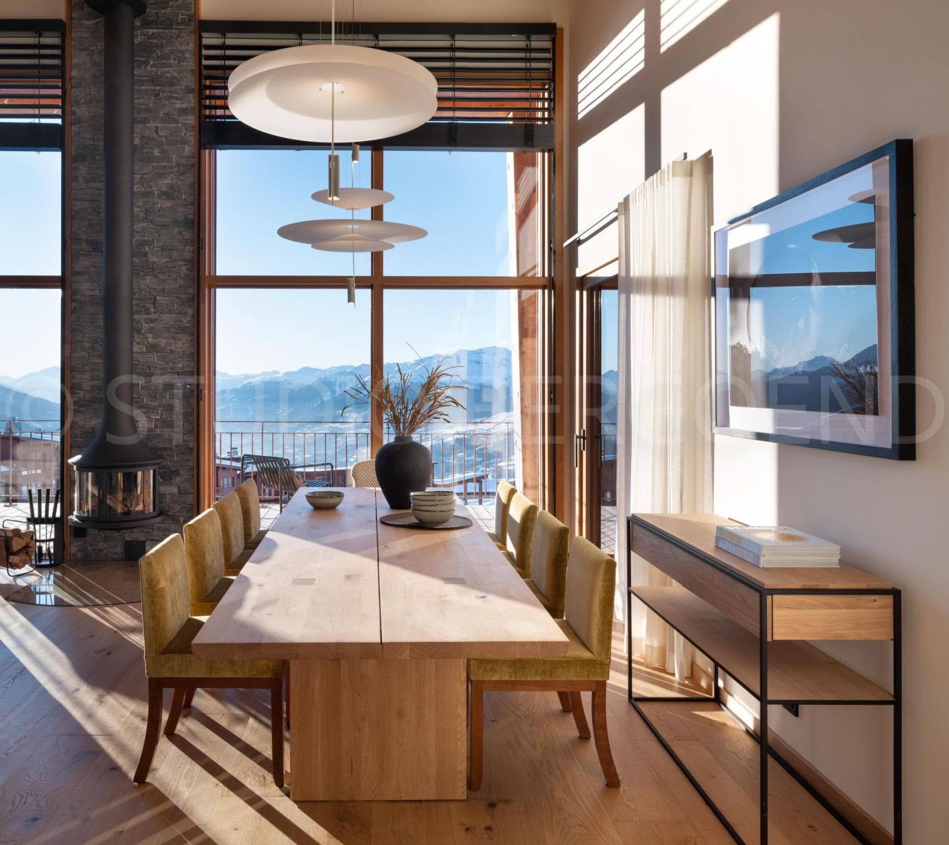 Dining area seats 8; floor-to-ceiling windows with mountain views and wood-burning stove