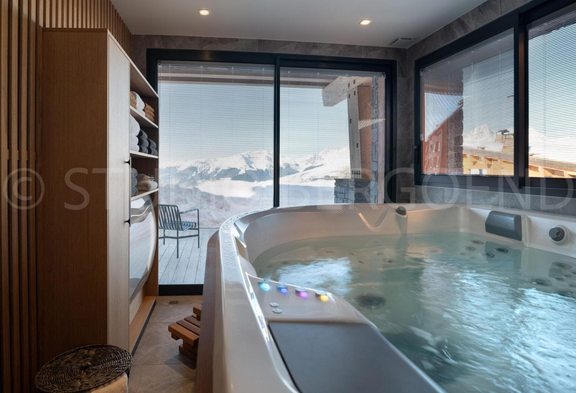 Indoor hot tub with mountain views and direct balcony access