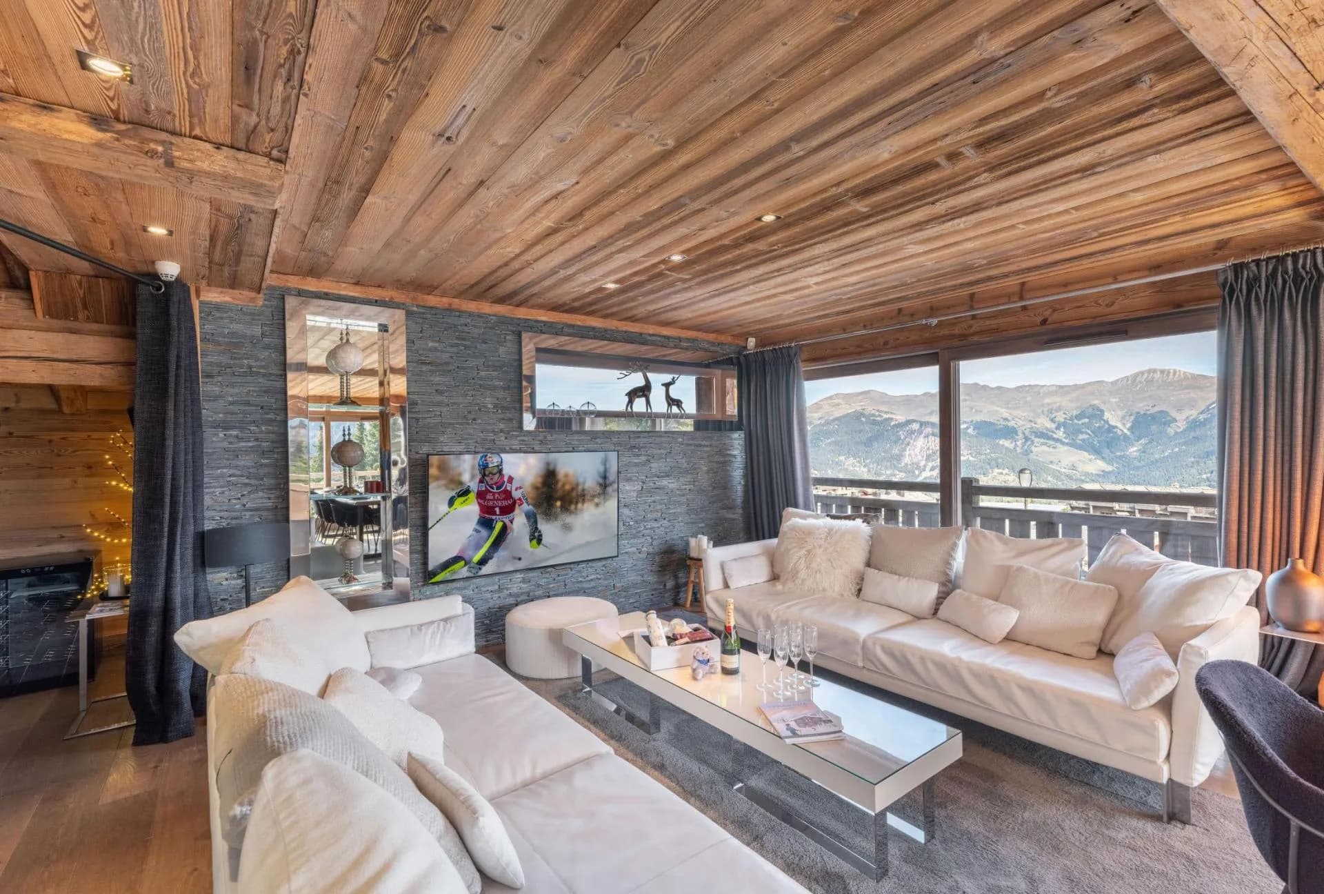 Sofa seating beside the ethanol fireplace and mountain views