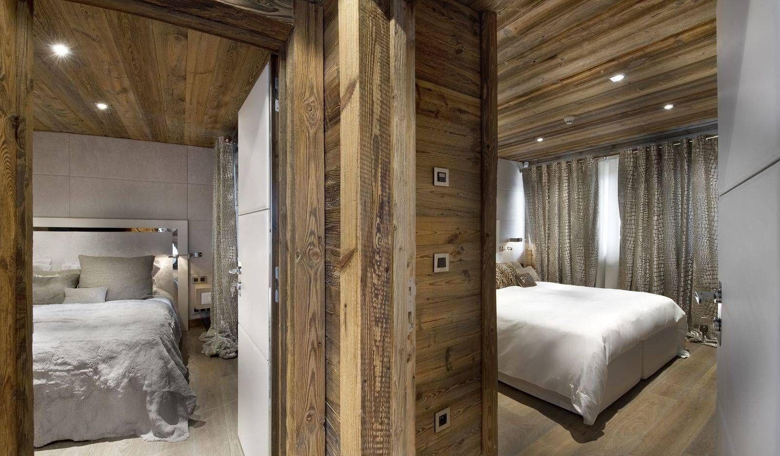 Double bedroom viewed through timber-framed mirrored doorway